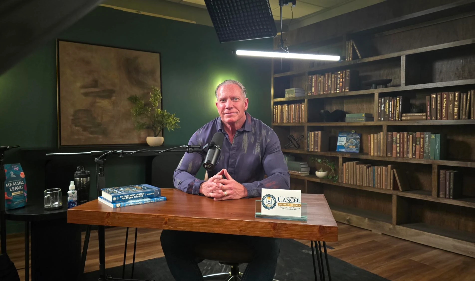 Ty Bollinger seated at the desk during filming of the Mastery Course